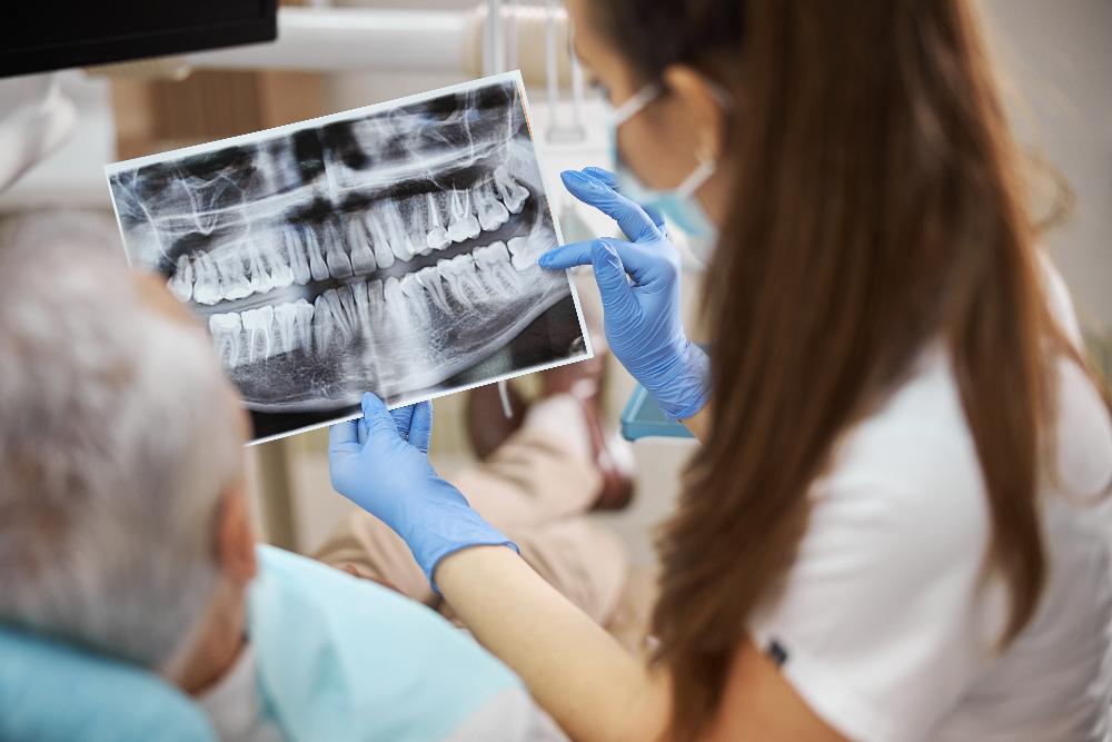 Woman dentist showing x-ray to patient, winston-salem nc