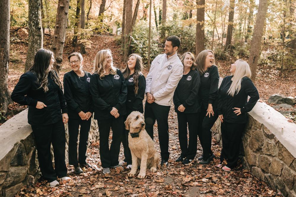 Benton and nelson dental team smiling at each other, winston salem nc