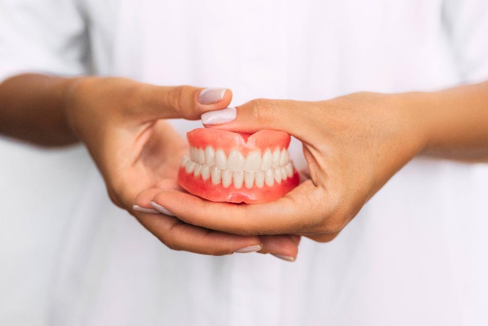 dentist holding denture mold | dentures winston salem nc
