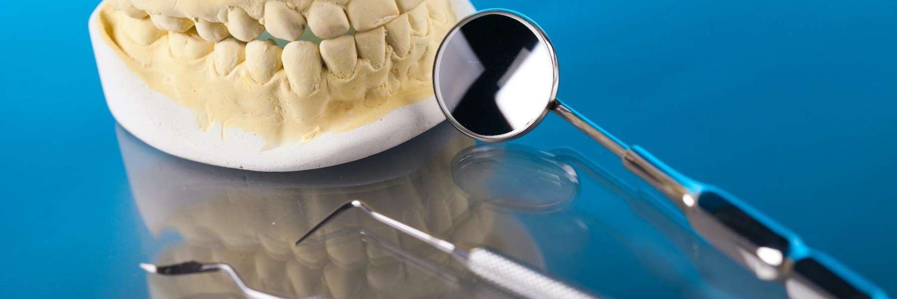 Dental tools next to a mold of teeth, winston-salem nc