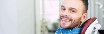 Young man in dental chair after teeth whitening, winston-salem nc