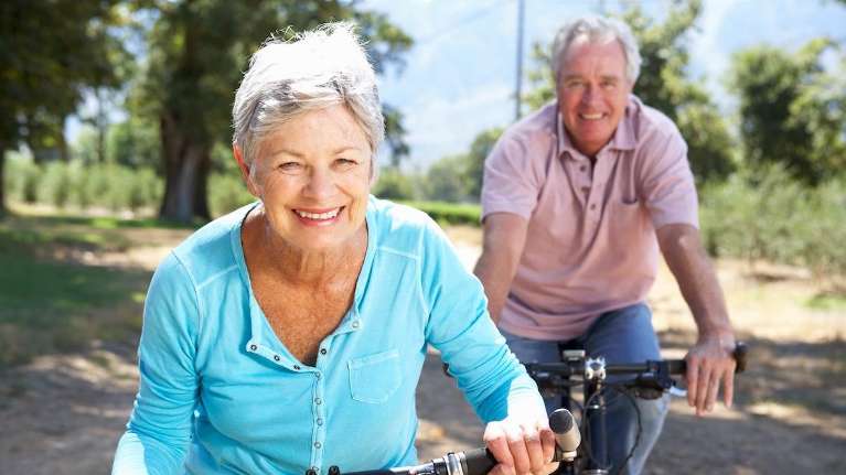 Older man and woman riding bikes, winston-salem nc
