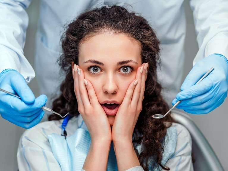 Woman with both hands on face in shock, winston-salem nc