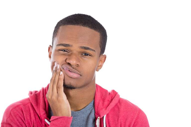 Young black man holding his jaw in pain, winston-salem nc