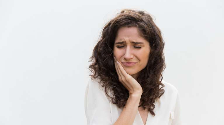 Woman holding her jaw in pain, winston-salem nc