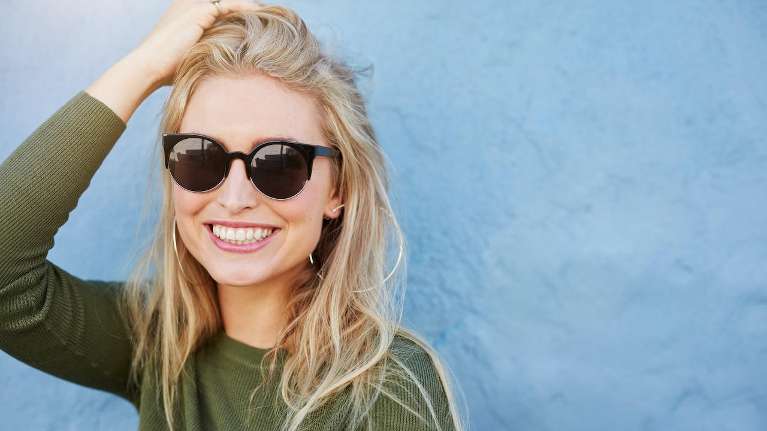 Blonde woman in sunglasses smiling, winston-salem nc