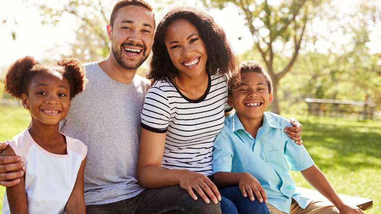 Black family smiling together after family dentistry treatment, winston-salem nc