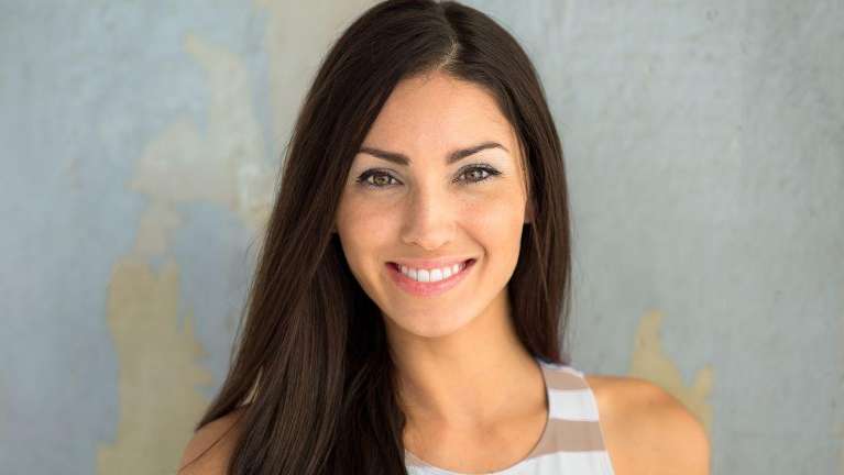 woman with dark hair smiling | cosmetic dentist winston salem nc