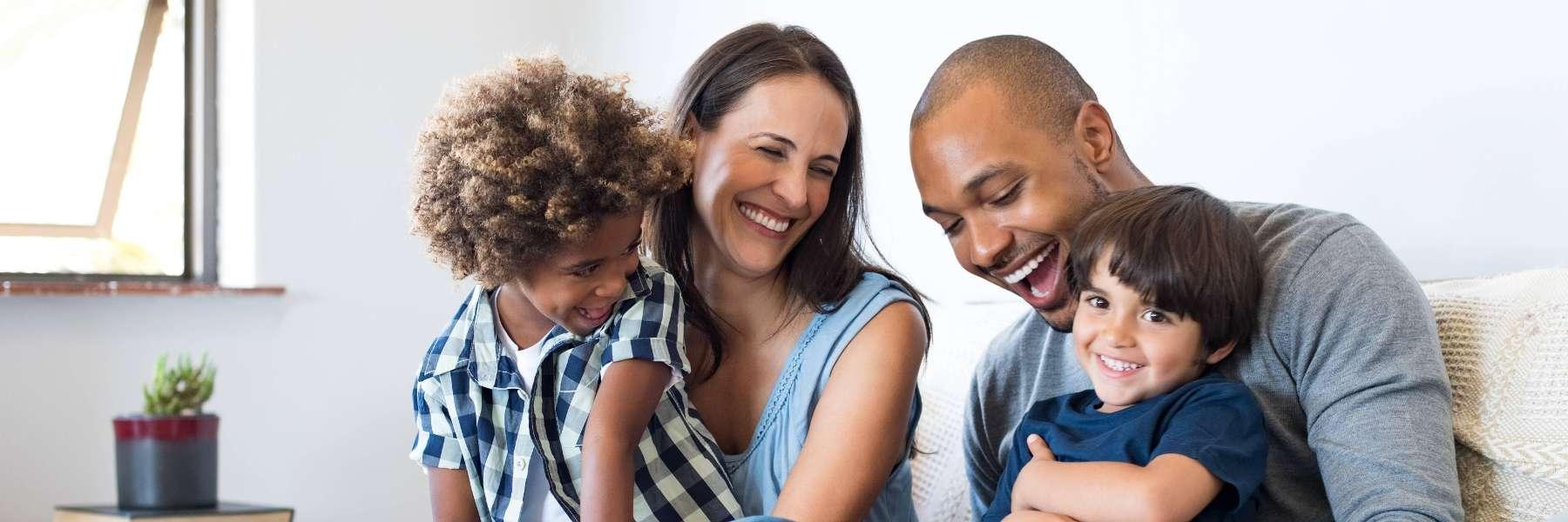 family of four hugging | dentist winston salem