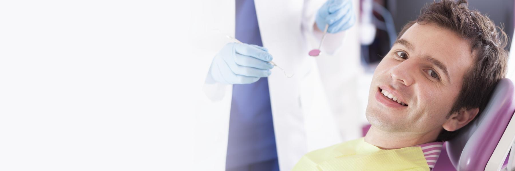 Man in dental chair smiling after emergency dentistry, winston-salem nc
